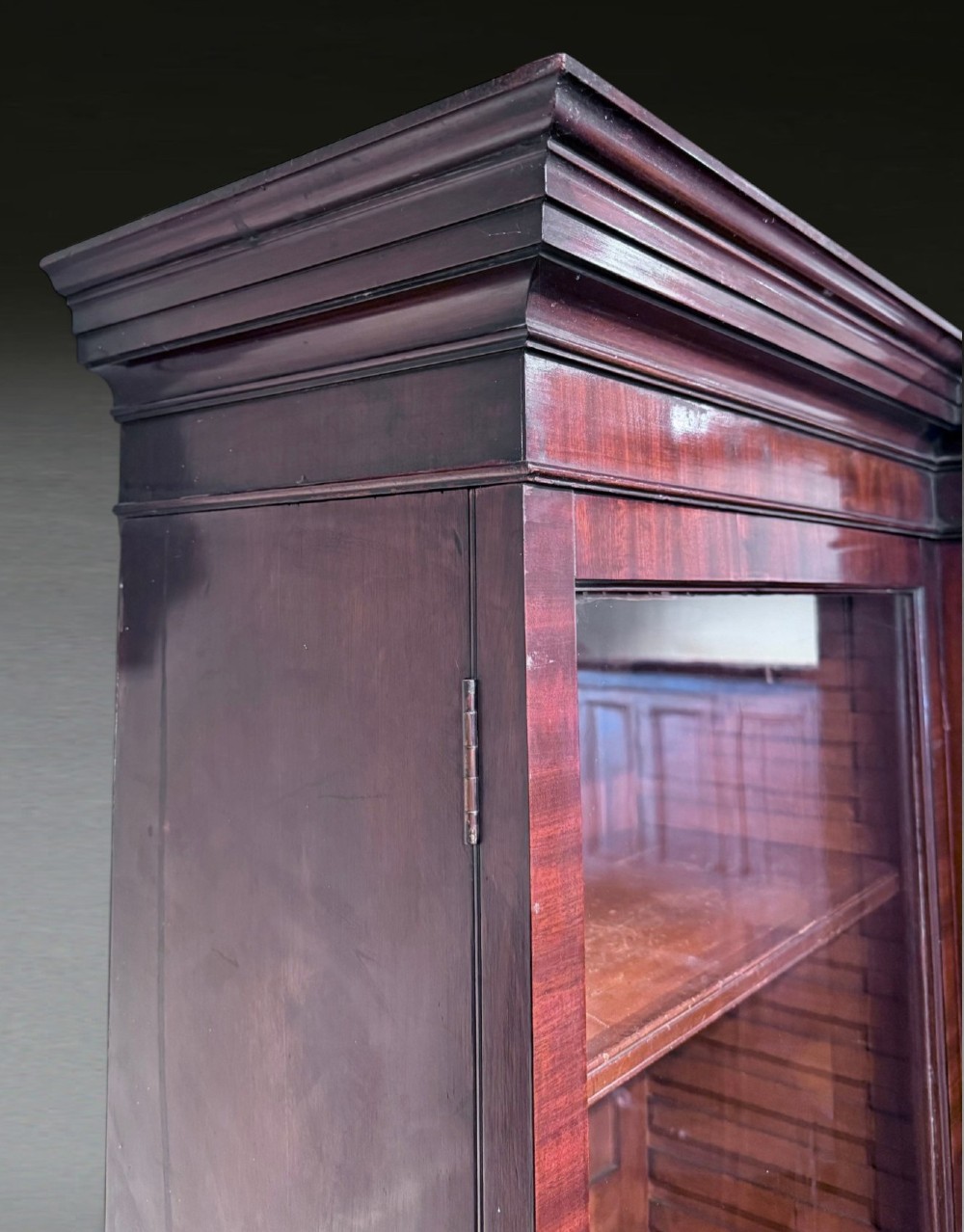A Georgian flame mahogany breakfront bookcase featuring glazed upper doors and panelled lower cupboard doors. View X