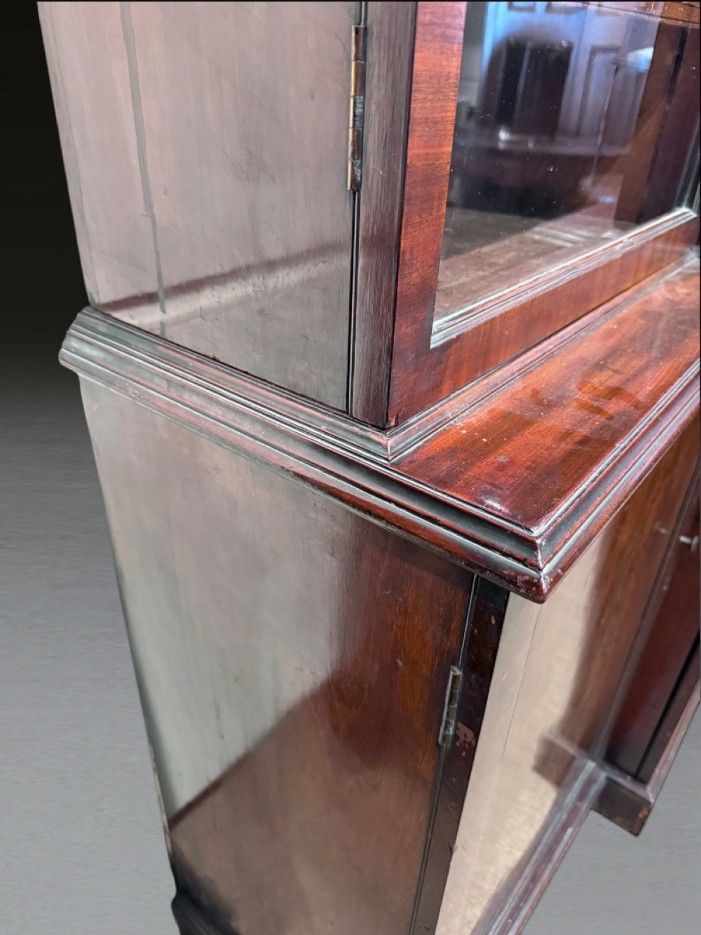 A Georgian flame mahogany breakfront bookcase featuring glazed upper doors and panelled lower cupboard doors. View XI