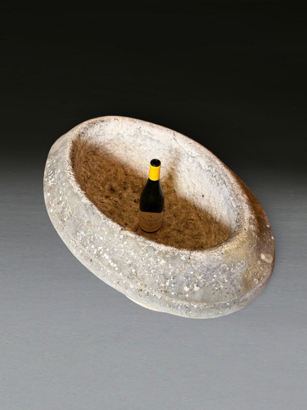 A hand-carved 18th-century grey marble cistern featuring a wide moulded rim and a heavy circular pedestal base. View VI