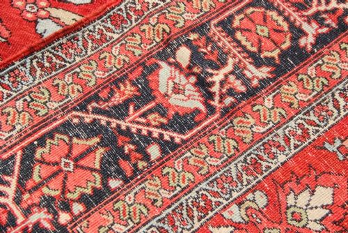 A large antique Persian Heriz carpet featuring an all-over geometric pattern in red, navy blue, and cream tones with a decorative border. View VIII