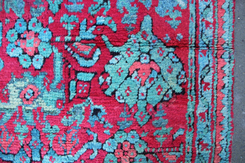 An elongated antique Oushak runner featuring an intricate floral pattern in shades of green and pink on a vibrant ground. View VI