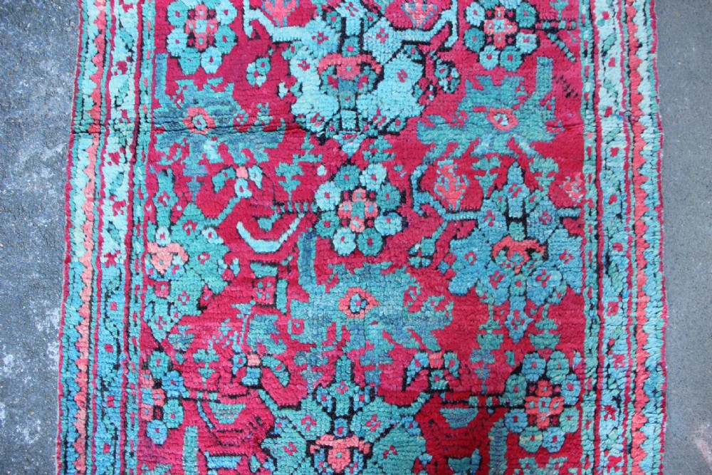 An elongated antique Oushak runner featuring an intricate floral pattern in shades of green and pink on a vibrant ground. View VIII