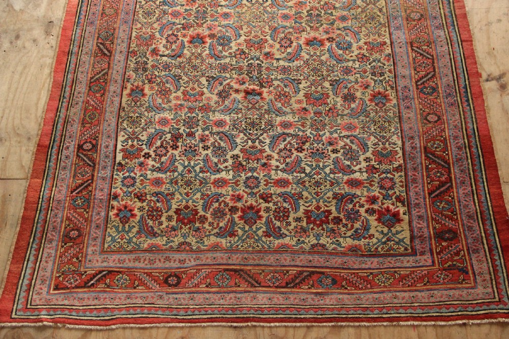A large hand-knotted antique Bakhshaish wool carpet featuring a dense floral lattice pattern on a cream field surrounded by a terracotta border. View II