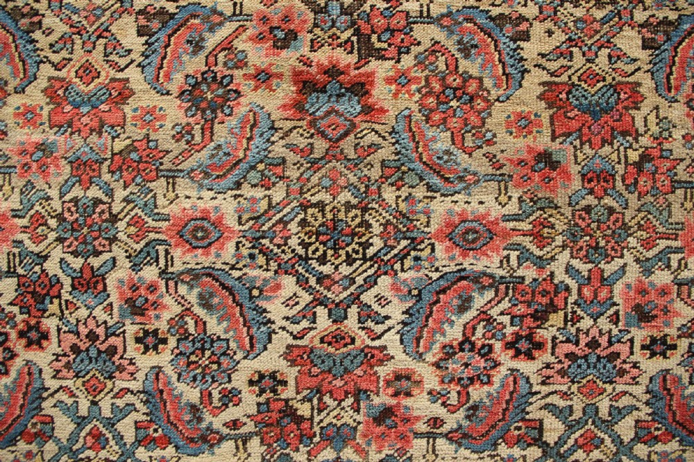 A large hand-knotted antique Bakhshaish wool carpet featuring a dense floral lattice pattern on a cream field surrounded by a terracotta border. View IV