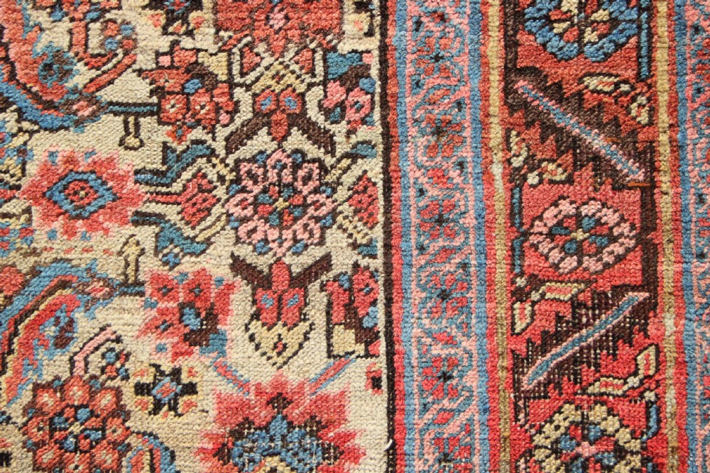 A large hand-knotted antique Bakhshaish wool carpet featuring a dense floral lattice pattern on a cream field surrounded by a terracotta border. View VII