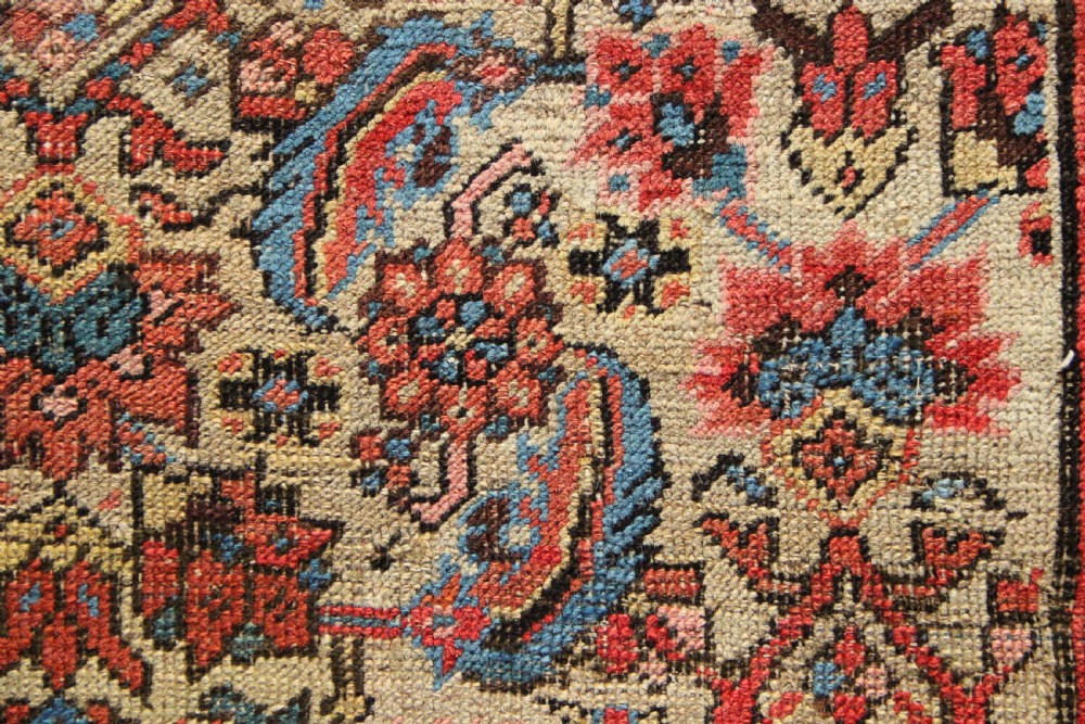 A large hand-knotted antique Bakhshaish wool carpet featuring a dense floral lattice pattern on a cream field surrounded by a terracotta border. View VIII