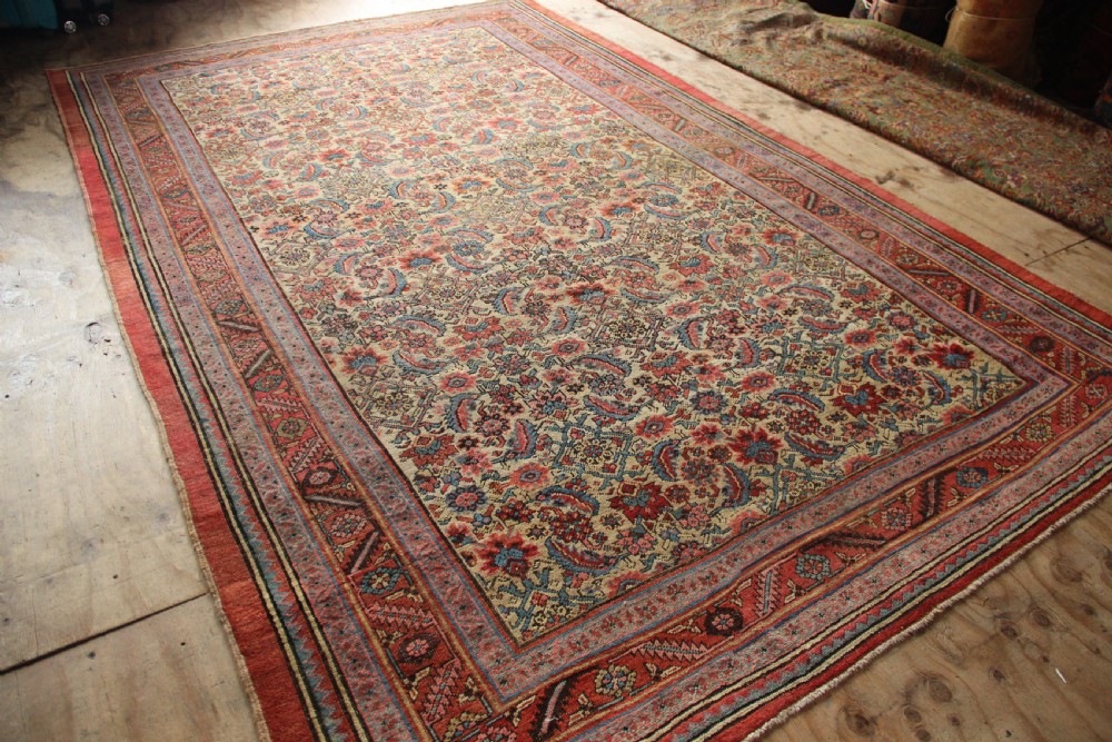 A large hand-knotted antique Bakhshaish wool carpet featuring a dense floral lattice pattern on a cream field surrounded by a terracotta border. View IX