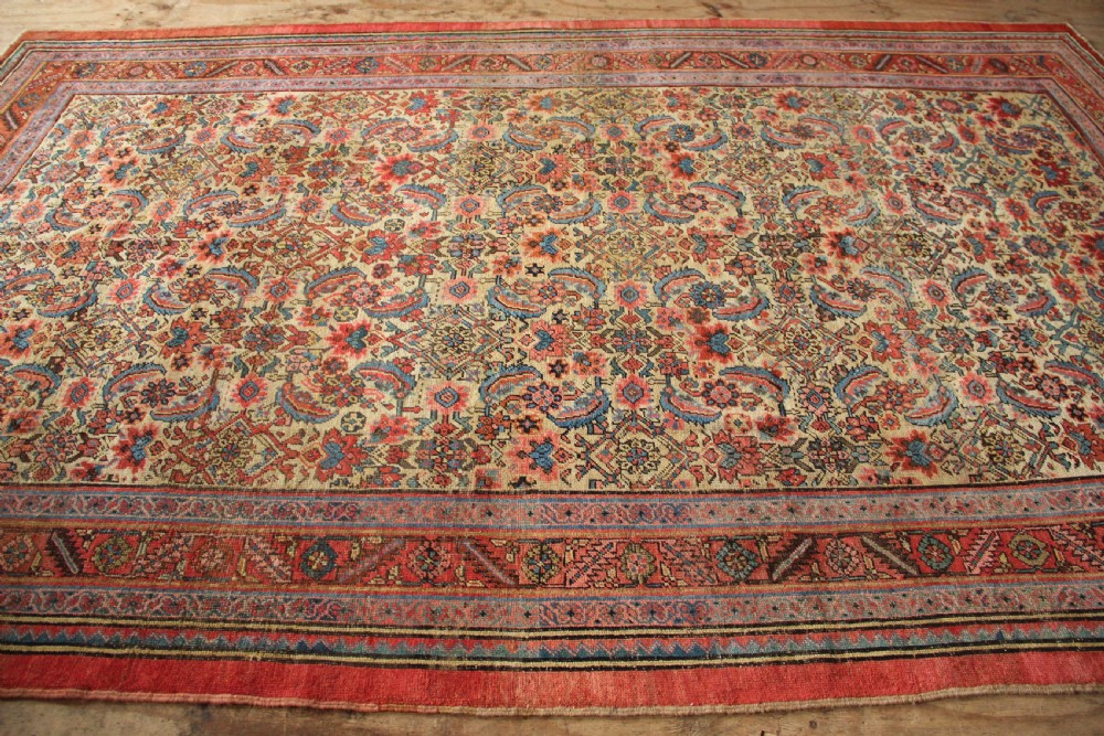 A large hand-knotted antique Bakhshaish wool carpet featuring a dense floral lattice pattern on a cream field surrounded by a terracotta border. View XI