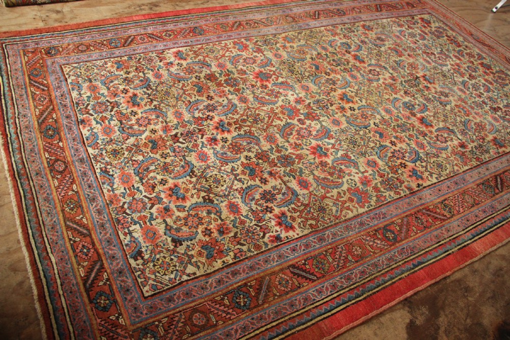 A large hand-knotted antique Bakhshaish wool carpet featuring a dense floral lattice pattern on a cream field surrounded by a terracotta border. View XII