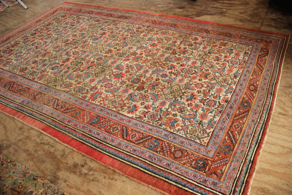 A large hand-knotted antique Bakhshaish wool carpet featuring a dense floral lattice pattern on a cream field surrounded by a terracotta border. View XIII