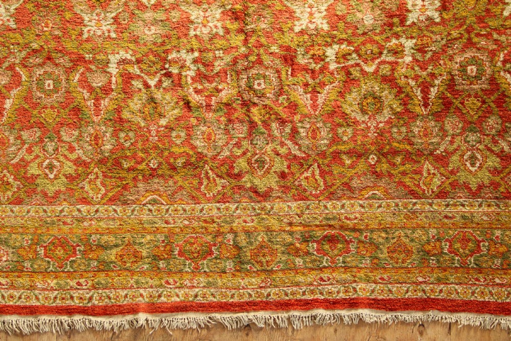 A square hand-knotted antique Ziegler wool carpet featuring a terracotta red field filled with intricate floral palmettes and framed by multi-tiered decorative borders. View II