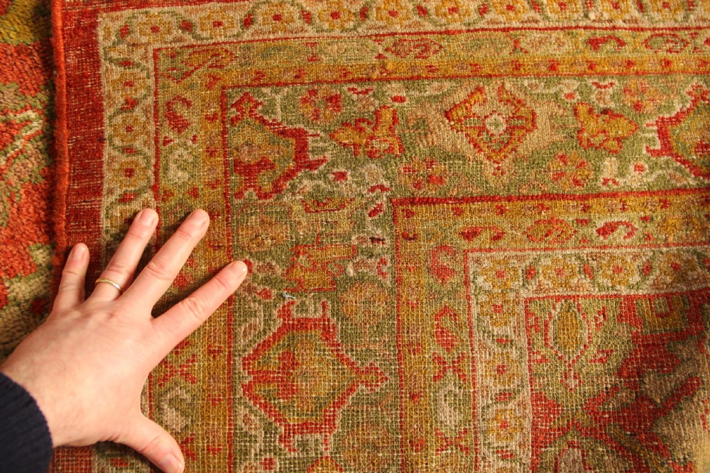 A square hand-knotted antique Ziegler wool carpet featuring a terracotta red field filled with intricate floral palmettes and framed by multi-tiered decorative borders. View III