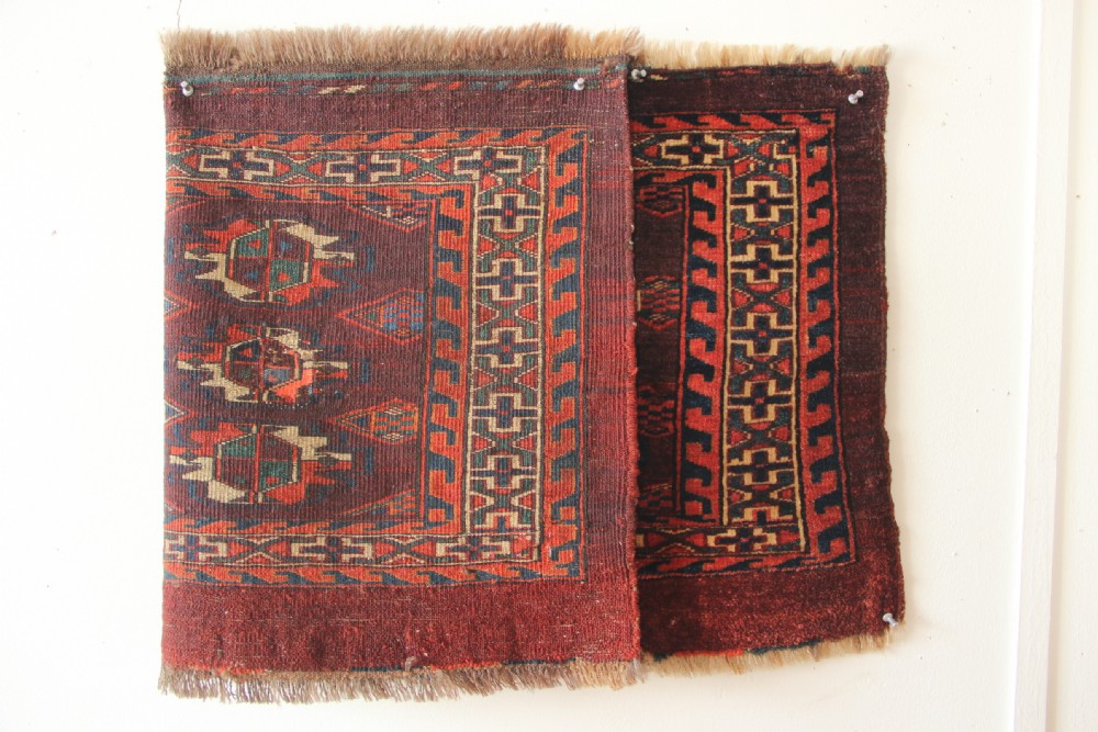 An antique hand-woven Yomud Mafrash wool textile panel featuring repeating geometric gul motifs in dark red, cream, and blue tones. View VII