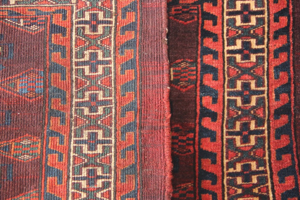 An antique hand-woven Yomud Mafrash wool textile panel featuring repeating geometric gul motifs in dark red, cream, and blue tones. View VIII