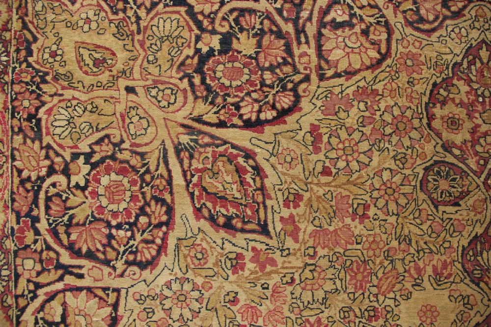 A large hand-knotted Persian Lavar Kirman carpet featuring a complex central floral medallion, intricate corner spandrels, and multi-layered decorative borders in cream, rose pink, and navy blue. View VIII