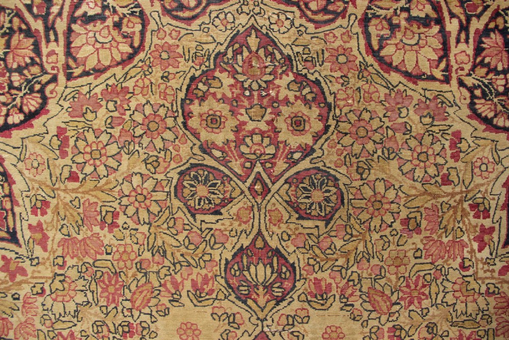 A large hand-knotted Persian Lavar Kirman carpet featuring a complex central floral medallion, intricate corner spandrels, and multi-layered decorative borders in cream, rose pink, and navy blue. View IX