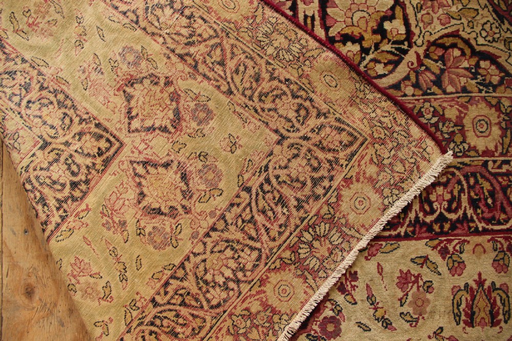 A large hand-knotted Persian Lavar Kirman carpet featuring a complex central floral medallion, intricate corner spandrels, and multi-layered decorative borders in cream, rose pink, and navy blue. View XIII