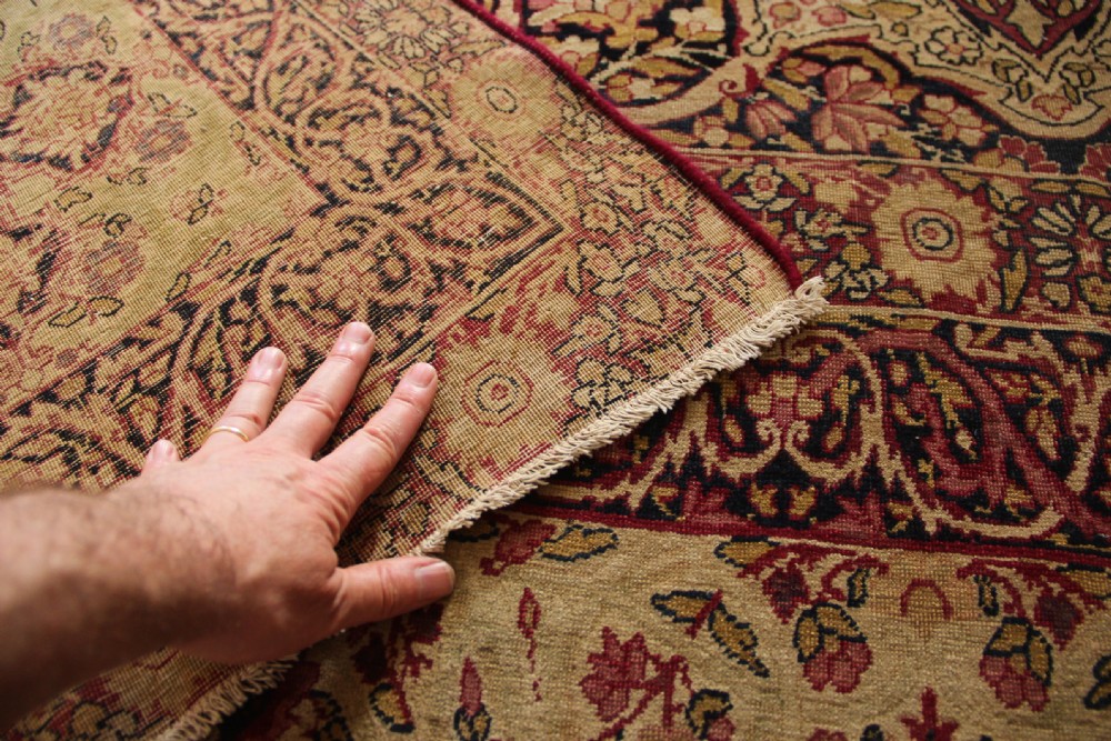A large hand-knotted Persian Lavar Kirman carpet featuring a complex central floral medallion, intricate corner spandrels, and multi-layered decorative borders in cream, rose pink, and navy blue. View XIV