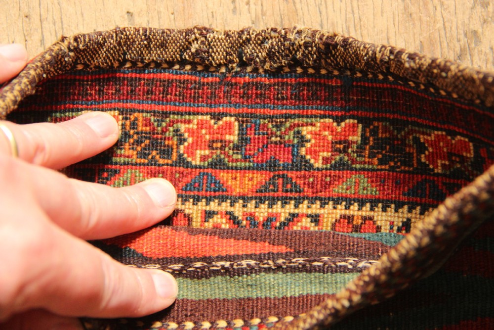 A small rectangular handwoven Persian Afshar chanteh featuring a crimson and indigo central floral motif framed by a patterned geometric border. View V
