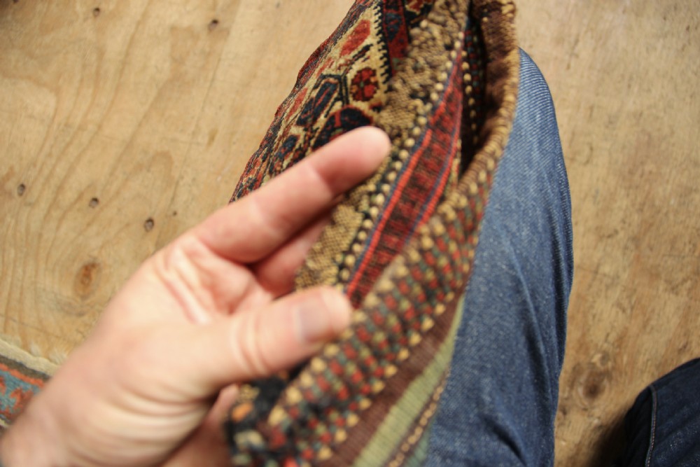 A small rectangular handwoven Persian Afshar chanteh featuring a crimson and indigo central floral motif framed by a patterned geometric border. View VI