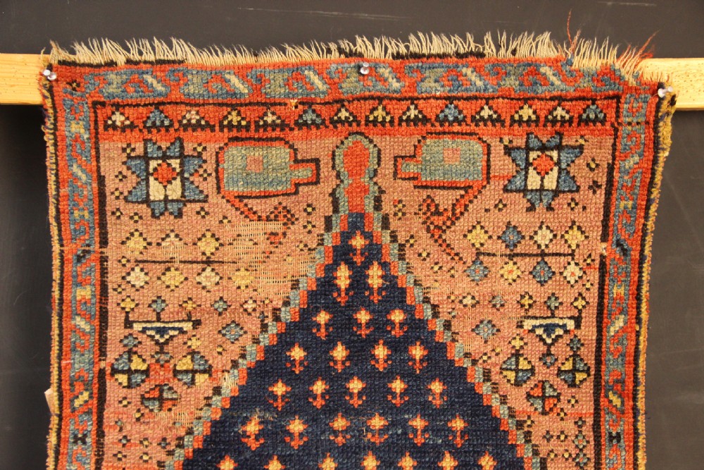 An early nineteenth-century Anatolian Konya yastik rug featuring a central navy blue diamond medallion set against a terracotta woven background with geometric borders. View III