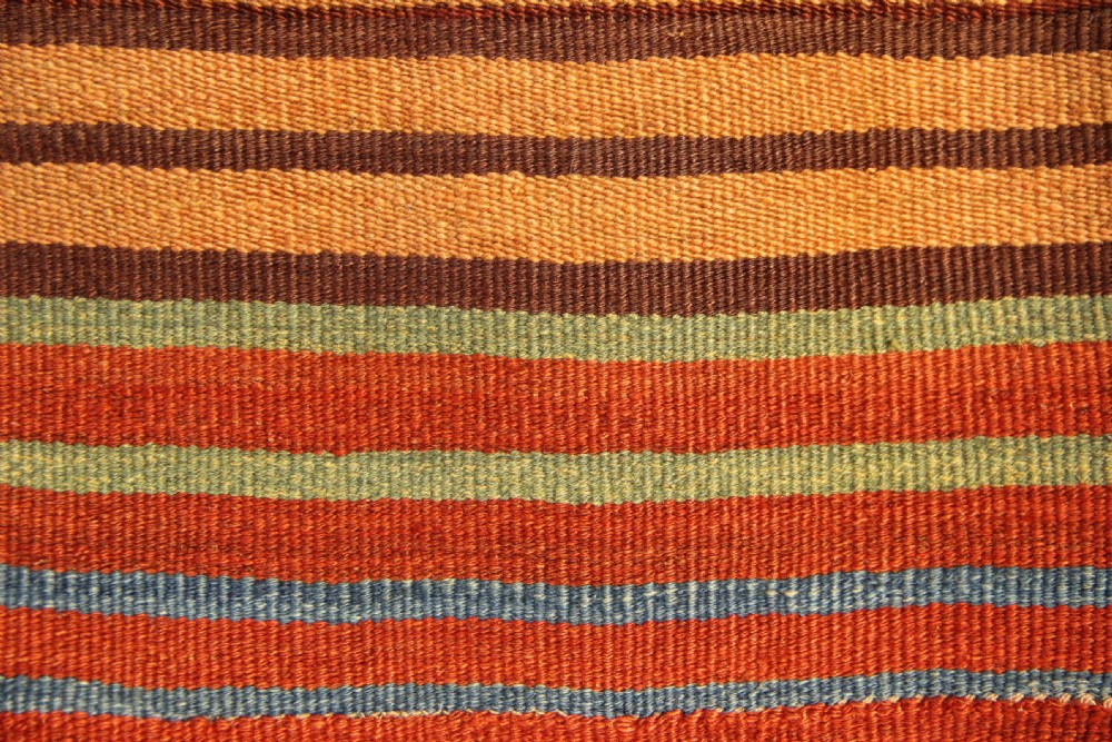 An antique square Shahsavan Soumac woven saddlebag face featuring geometric diamond medallions in terracotta red, navy, and soft blue wool. View VIII