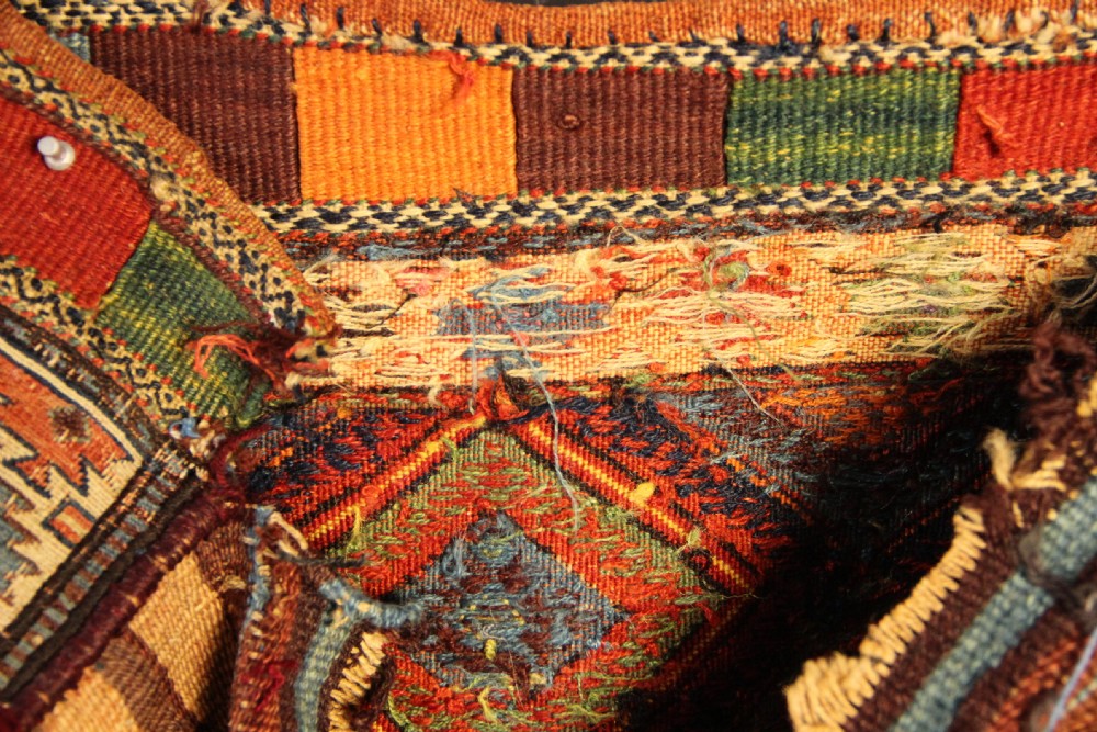 An antique square Shahsavan Soumac woven saddlebag face featuring geometric diamond medallions in terracotta red, navy, and soft blue wool. View IX