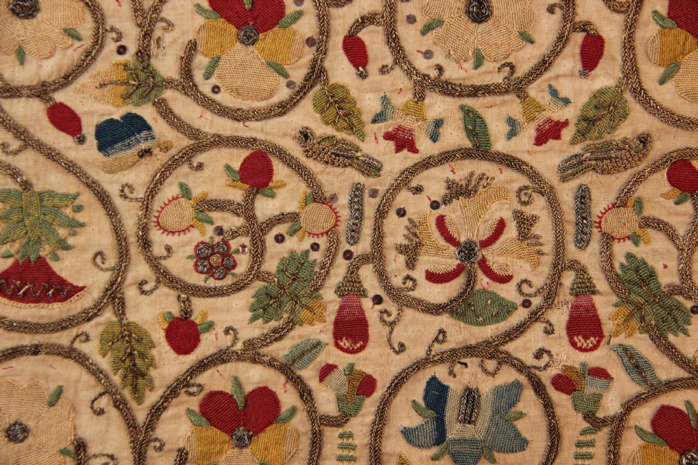 An unstitched early 17th-century rectangular linen embroidery panel decorated with scrolling metallic tendrils and polychrome silk flowers. View II