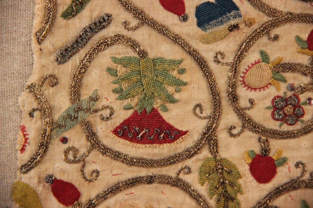An unstitched early 17th-century rectangular linen embroidery panel decorated with scrolling metallic tendrils and polychrome silk flowers. View III