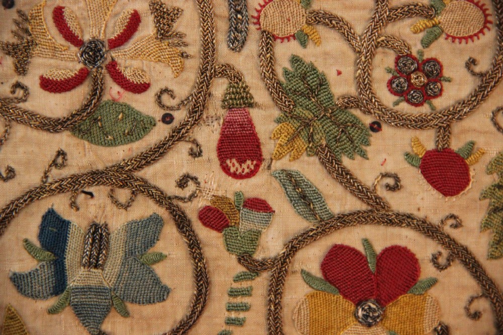An unstitched early 17th-century rectangular linen embroidery panel decorated with scrolling metallic tendrils and polychrome silk flowers. View IV