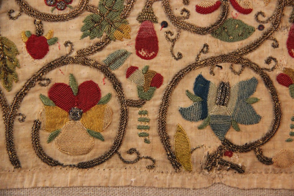 An unstitched early 17th-century rectangular linen embroidery panel decorated with scrolling metallic tendrils and polychrome silk flowers. View V