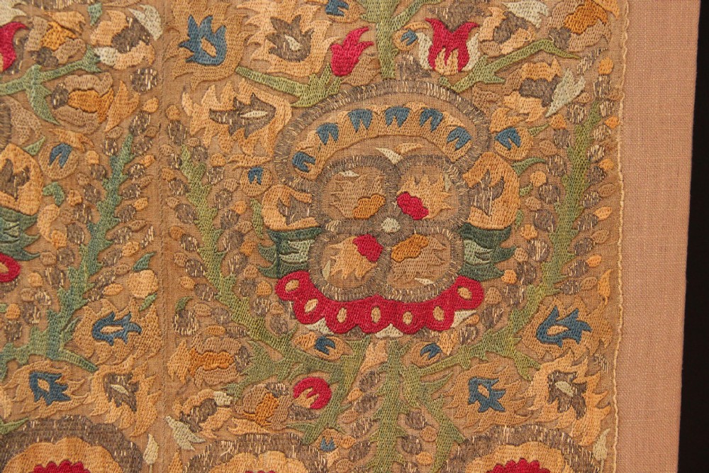 An 18th-century Greek embroidered linen panel featuring symmetrical botanical motifs stitched in red, green, ochre, and metallic thread. View II