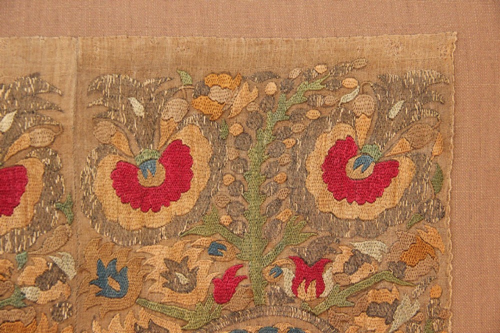 An 18th-century Greek embroidered linen panel featuring symmetrical botanical motifs stitched in red, green, ochre, and metallic thread. View III