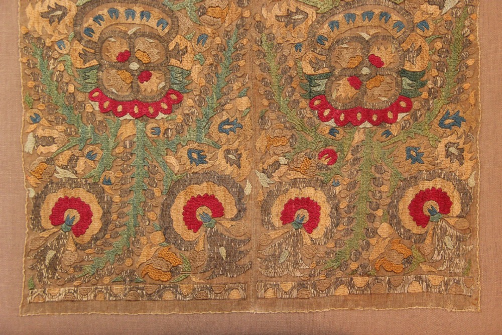 An 18th-century Greek embroidered linen panel featuring symmetrical botanical motifs stitched in red, green, ochre, and metallic thread. View IV