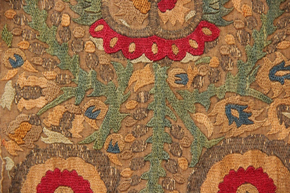 An 18th-century Greek embroidered linen panel featuring symmetrical botanical motifs stitched in red, green, ochre, and metallic thread. View V