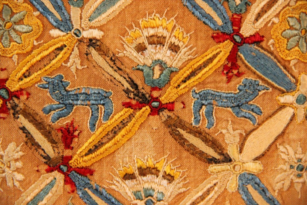 An 18th-century rectangular Cretan textile panel featuring polychrome silk embroidery on a natural beige linen ground with repeating geometric lattices, stylised human figures, birds, and floral motifs. View III