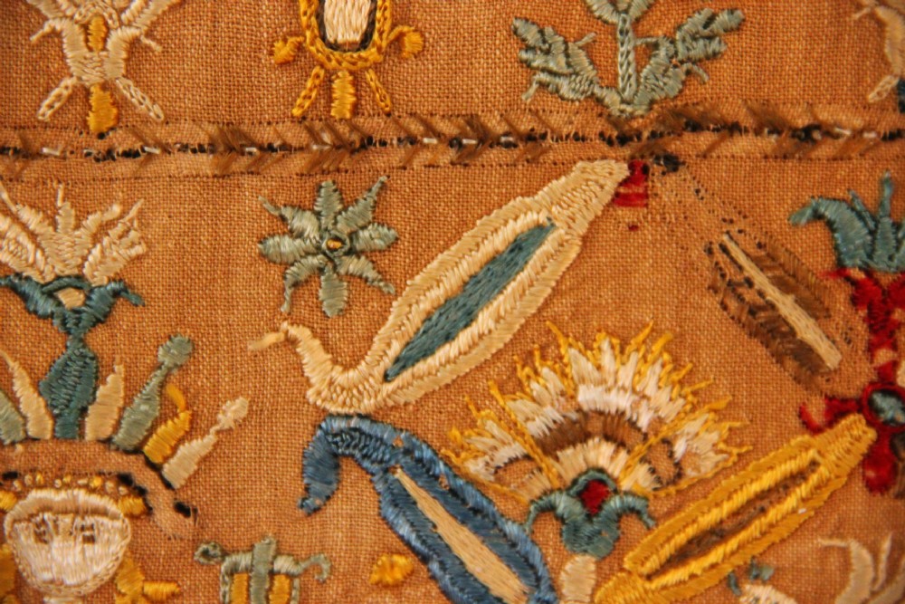 An 18th-century rectangular Cretan textile panel featuring polychrome silk embroidery on a natural beige linen ground with repeating geometric lattices, stylised human figures, birds, and floral motifs. View VI