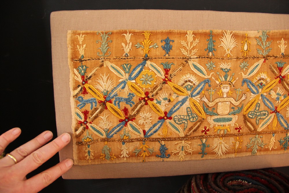 An 18th-century rectangular Cretan textile panel featuring polychrome silk embroidery on a natural beige linen ground with repeating geometric lattices, stylised human figures, birds, and floral motifs. View VII