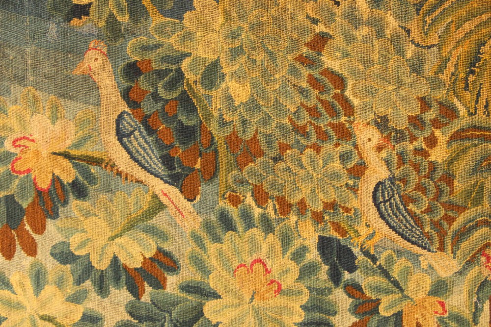 An 18th-century European needlework tapestry depicting lush botanical trees, perched birds, and floral motifs surrounded by a decorative foliate border. View V