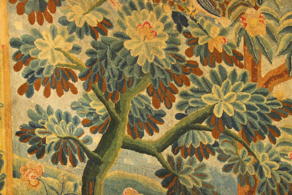 An 18th-century European needlework tapestry depicting lush botanical trees, perched birds, and floral motifs surrounded by a decorative foliate border. View VI