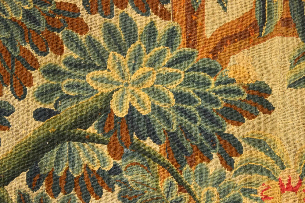 An 18th-century European needlework tapestry depicting lush botanical trees, perched birds, and floral motifs surrounded by a decorative foliate border. View VIII