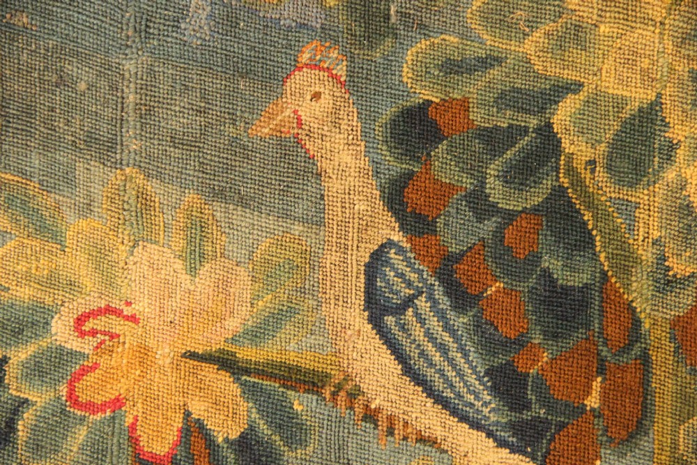 An 18th-century European needlework tapestry depicting lush botanical trees, perched birds, and floral motifs surrounded by a decorative foliate border. View IX
