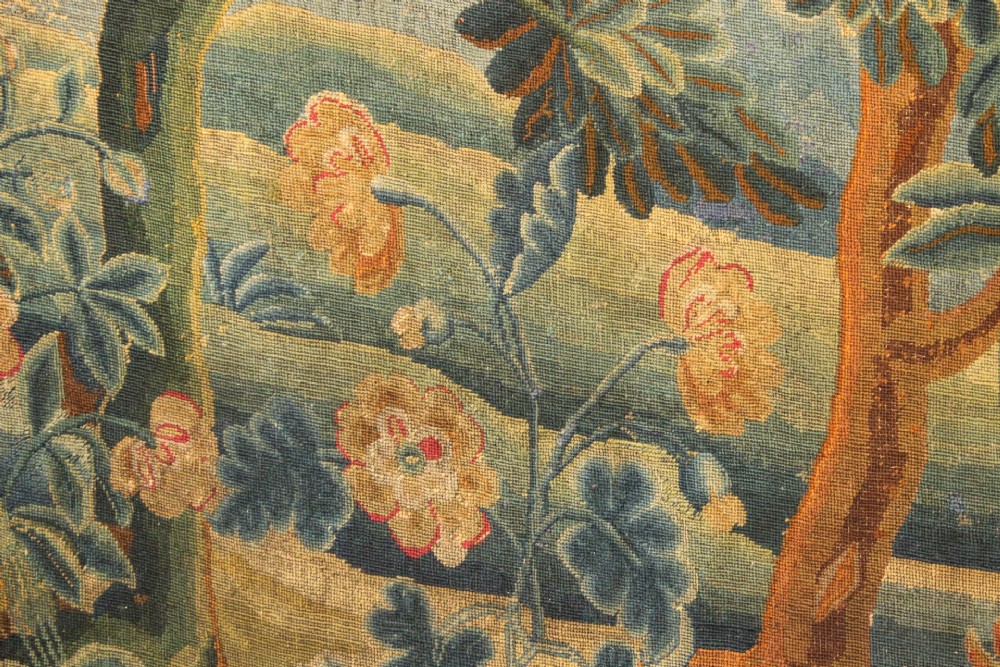 An 18th-century European needlework tapestry depicting lush botanical trees, perched birds, and floral motifs surrounded by a decorative foliate border. View X