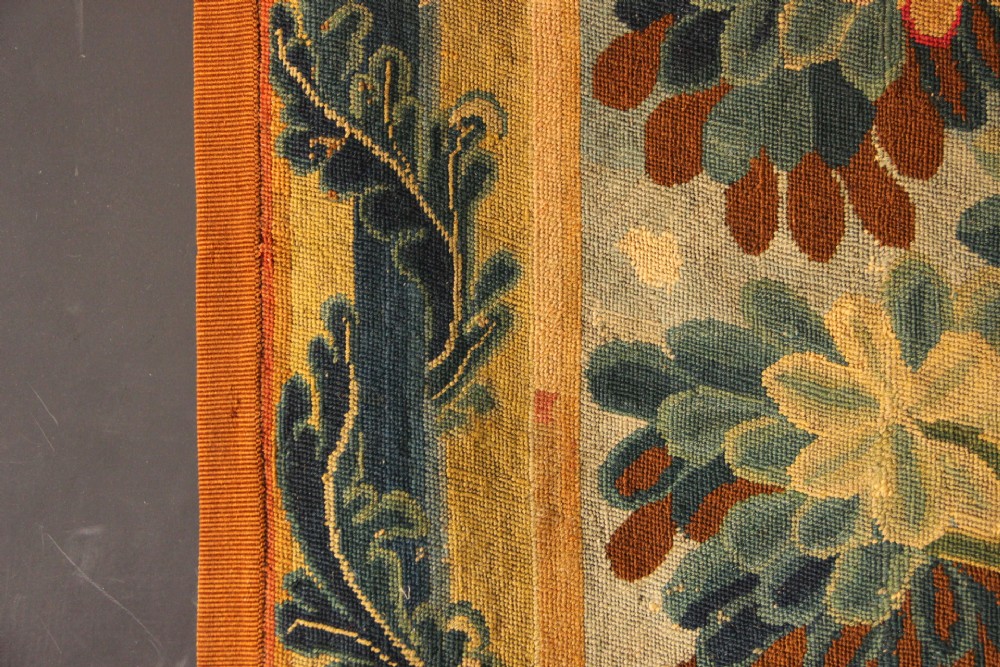 An 18th-century European needlework tapestry depicting lush botanical trees, perched birds, and floral motifs surrounded by a decorative foliate border. View XIV