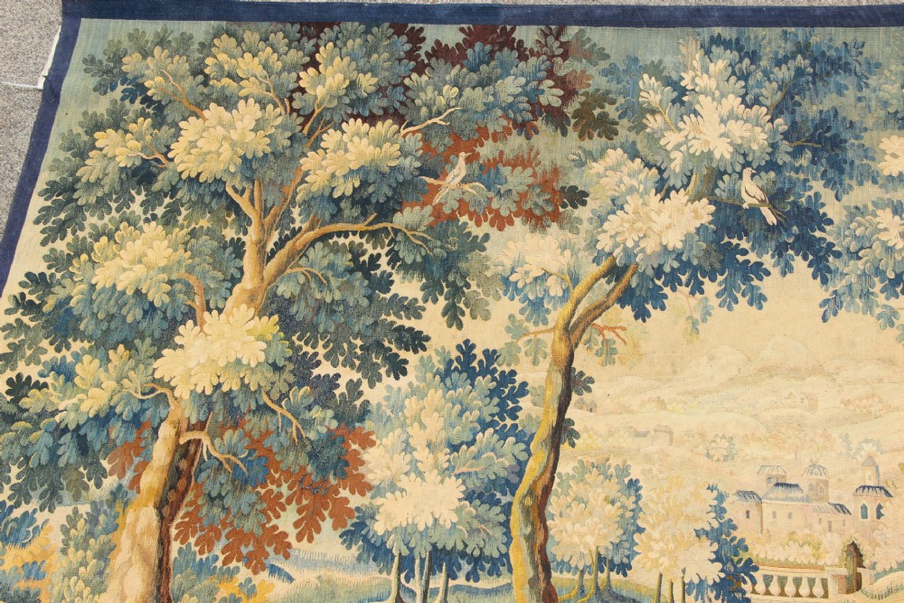 A large hand-woven French Aubusson verdure tapestry depicting swans swimming on a woodland river surrounded by trees and foliage. View V