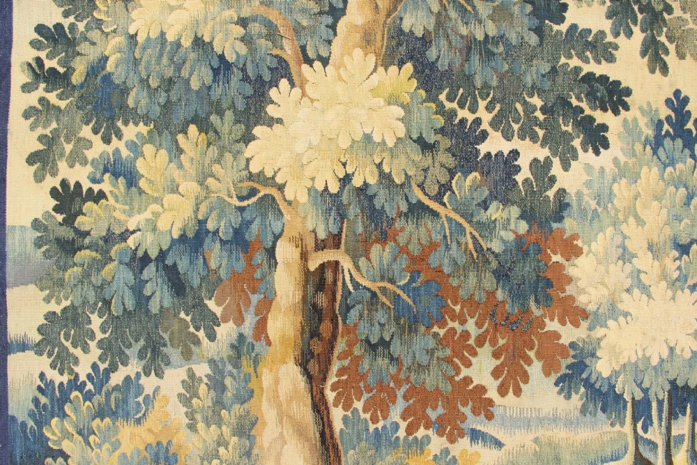A large hand-woven French Aubusson verdure tapestry depicting swans swimming on a woodland river surrounded by trees and foliage. View X