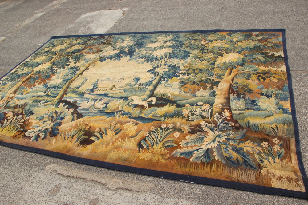 A large hand-woven French Aubusson verdure tapestry depicting swans swimming on a woodland river surrounded by trees and foliage. View XIV