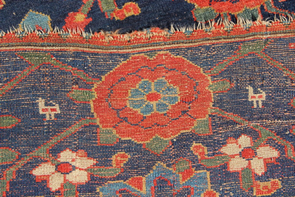 An extra-long hand-knotted antique Kurdish runner rug featuring a repeating Mina Khani floral lattice pattern in navy blue, rust red, and mustard yellow. View X
