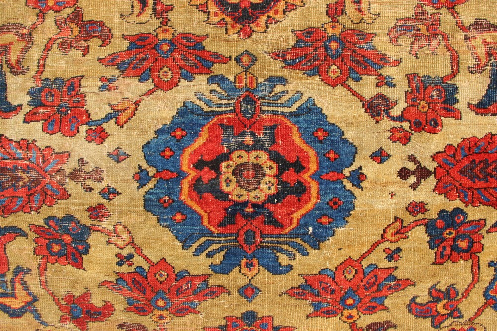 An antique hand-knotted Fereghan Persian carpet featuring a central cream field filled with red and navy floral motifs framed by a wide geometric border. View VI