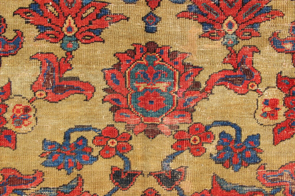 An antique hand-knotted Fereghan Persian carpet featuring a central cream field filled with red and navy floral motifs framed by a wide geometric border. View IX
